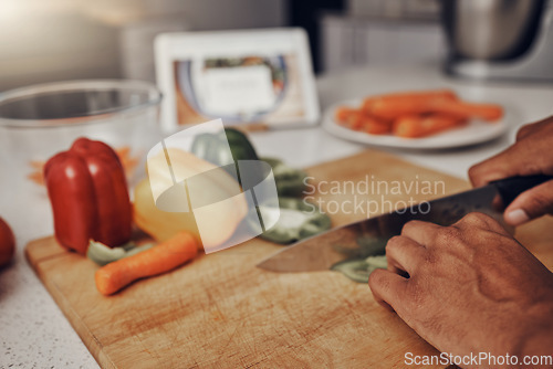 Image of Kitchen, cutting board and vegetables being cut for cooking a healthy, organic and delicious meal. Food, nutrition and chef chop or preparing fresh produce peppers for a diet dinner, lunch or supper.