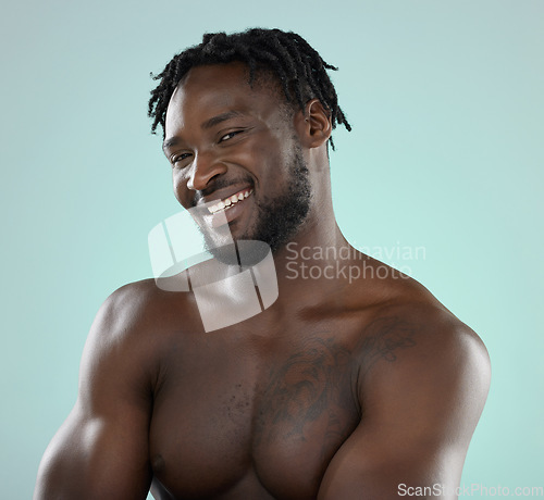 Image of Happy man, skincare and face portrait with a smile for beauty, hygiene and grooming in studio. Healthy black person on blue background for facial glow, clean skin and self care with dermatology