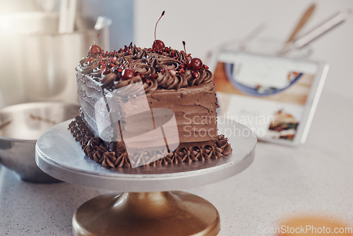 Image of Chocolate cake, table and home with bakery dessert for fine dining, cooking or celebration with cream. Luxury birthday food, restaurant and sugar brownie with coco icing for eating, gourmet or baking