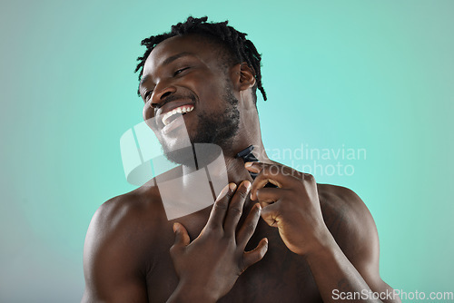 Image of Black man shaving face, skincare on studio background and razor on smooth facial hair growth. Happy young person grooming, hygiene product and model cleaning beard with cosmetic morning routine