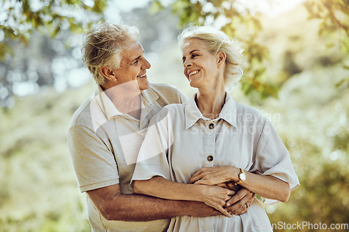 Image of Love, hug or old couple in a park or nature bonding or holding hands in a happy marriage partnership. Retirement, senior man or romantic elderly woman hugging together in a relaxing holiday vacation
