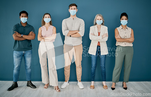 Image of Portrait, covid and group of business people with arms crossed in office for health and safety. Teamwork, compliance and workers, men and women with face mask or ppe to stop corona virus for wellness