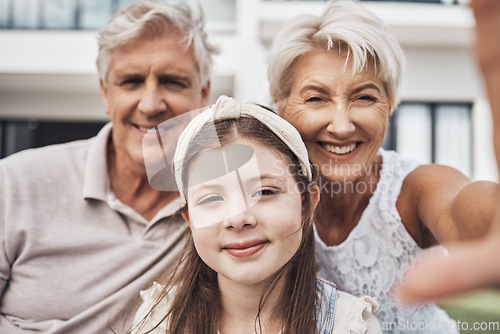 Image of Portrait, grandparents and child love taking a selfie as a happy family in summer holidays in a backyard. Elderly, relax or girl smiles in a picture while bonding with grandmother and old man at home