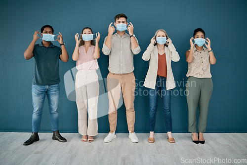 Image of Portrait, covid and group of business people in office for health and safety. Teamwork, compliance and employees, men and women with face mask or ppe to stop corona virus for wellness in workplace.