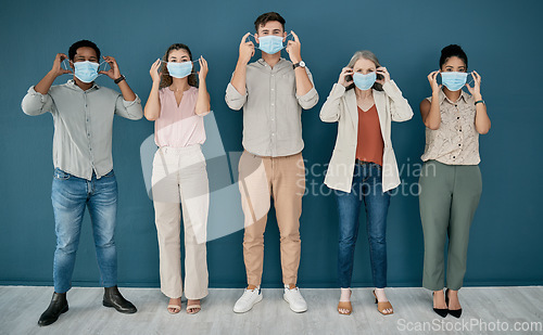 Image of Covid, portrait and group of business people in office for health and safety. Teamwork, compliance and employees, men and women with face mask or ppe to stop corona virus for wellness in workplace.