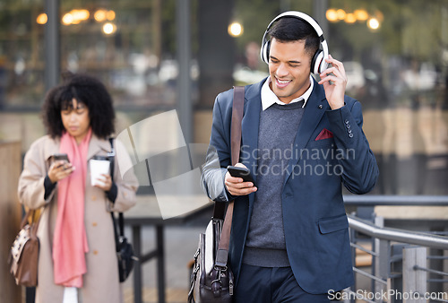 Image of Businessman, walk in city with music, phone or headphones for audio, chat communication or social media. Corporate man, woman during travel in city with smartphone, typing or reading for networking