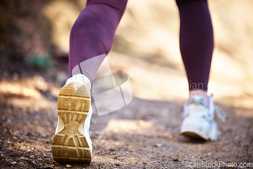 Image of Running, health and shoes of woman in nature park for workout, fitness and cardio training. Wellness, sports and stamina endurance with girl runner jogging in forest for progress goals, exercise