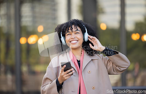 Image of Black woman listening to music in city travel for mental health, energy and calm podcast with a smile. Happy, urban student in headphones or audio technology, streaming app on her way to university