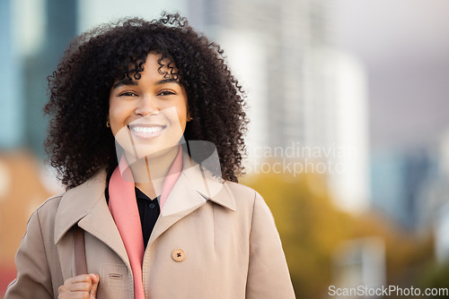 Image of Black woman, business portrait and city travel with smile outdoor on New york street happy about freedom. Face of young person with natural hair, beauty and fashion on walk with urban buildings space