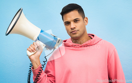 Image of Man, portrait or megaphone for protest, human rights equality or freedom campaign on isolated blue background. Student, person or model with loud speaker for empowerment speech, justice or revolution