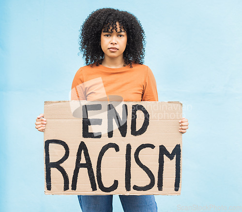 Image of Black woman protest, sign and anger in portrait, racism and equality, human rights and freedom isolated on blue background. Global problem, social justice and revolution, angry in studio and politics