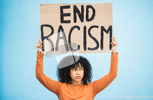 Image of Black woman protest, sign and angry at racism, fight for equality, human rights and freedom isolated on blue background. Global problem, social justice and revolution, anger in studio and politics