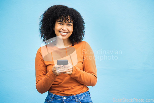 Image of Happy black woman, fashion or phone typing on isolated blue background on Brazil city app, social media or internet. Smile, person or student model on mobile communication technology by wall mock up