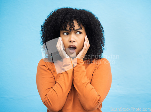 Image of Wow, surprise and idea with a black woman in shock standing on a blue background in studio. Omg, confused and thinking with an attractive young female looking shocked or surprised indoor