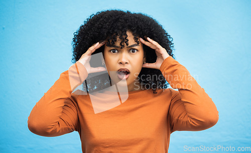 Image of Wow, surprise and portrait with a black woman in shock standing on a blue background in studio. Omg, confused and face with an attractive young female looking shocked or surprised indoor