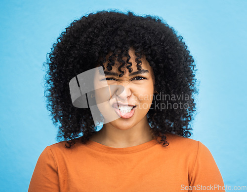 Image of Portrait, emoji and woman with facial expression in studio for fun, relax and playful attitude on blue background. Face, comic and goofy black woman with a funny face, crazy and personality isolated
