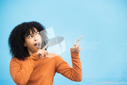 Image of Black woman, wow or pointing hands at promotion mockup, advertising space or marketing mock up on blue background. Surprised, shocked or curious afro model with showing gesture at isolated sales deal