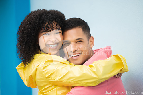 Image of Couple, smile and hug in portrait with face, love and commitment, happiness isolated on blue background. Interracial relationship, support and together in studio with happy people and trust