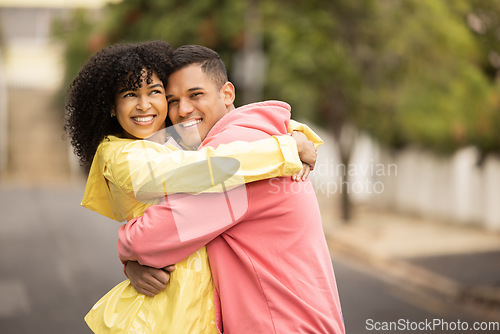 Image of Happy couple, bonding and portrait hug on city road, street or urban sidewalk in travel, people date or holiday break. Smile, man and black woman in love embrace, security or trust cuddle for support