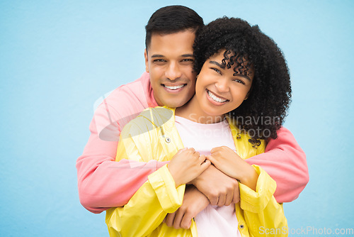 Image of Happy people, smile and hug in portrait with couple in love, commitment isolated on blue background. Interracial relationship mockup, commitment and together in studio with black woman, man and trust