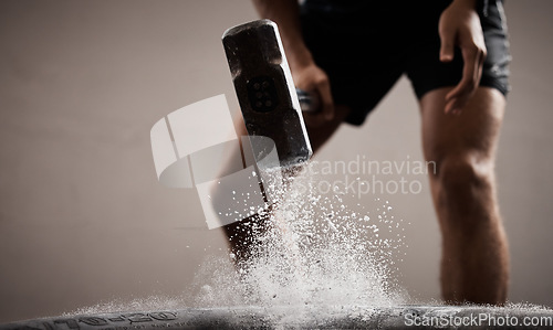 Image of Workout, dust and hands hammer tire in studio isolated on a brown background mockup. Sports, fitness and male, athlete or man hammering tyre with chalk powder for training, exercise and muscle power.