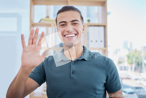 Image of Wave, greeting and portrait of a man in the office for an online meeting, webinar or video call. Happy, smile and professional male employee waving his hand for welcome while working in the workplace