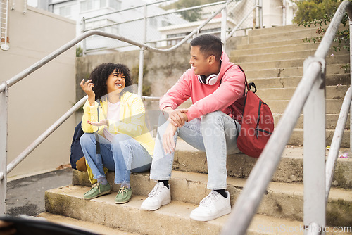 Image of Student, friends and conversation on stairs talking about social life, class or education at the campus. Young academic university or college students chilling on staircase in funny discussion