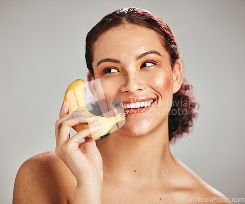 Image of Beauty makeup, face and woman with banana phone for facial skincare glow, fruit detox or natural dermatology. Wellness health product, nutritionist food and happy model isolated on studio background