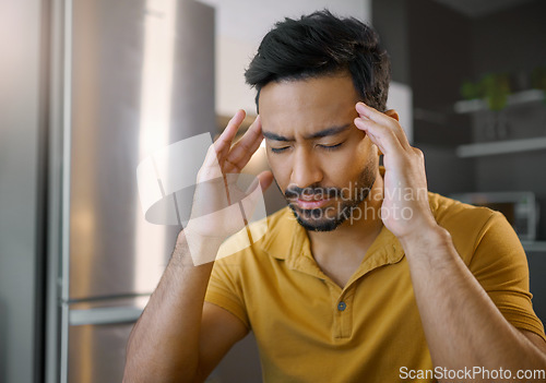 Image of Businessman, home office and stress headache in kitchen for mindset focus, mental health and work fatigue. Digital entrepreneur thinking, business owner and anxiety in house, tired and frustrated