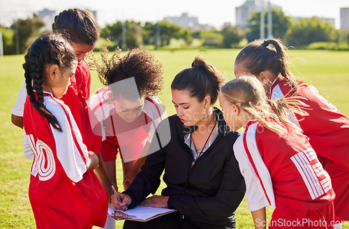 Image of Planning, sports or coach with children for soccer strategy, training or health goals in Canada. team building, teamwork and woman coaching group of girls on football field for game, match or workout