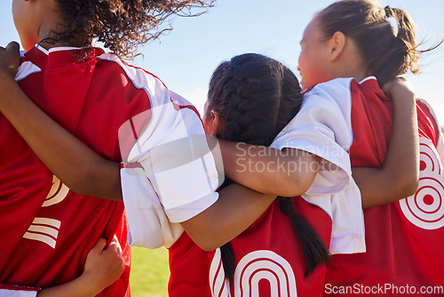 Image of Girl, soccer group and back with huddle on field for match, contest or game with team building support. Female kids, football player children and hug for solidarity, diversity or motivation on pitch