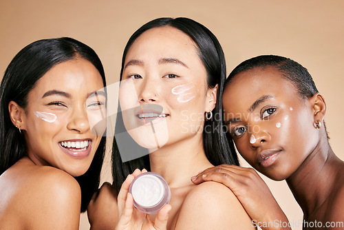 Image of Beauty, portrait and face cream by diverse women in studio for wellness or grooming on brown background. Friends, skincare and skin lotion for girl group with different, facial and product isolated