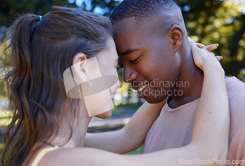 Image of Love, park and face with an interracial couple bonding or hugging outdoor together on a romantic date in nature. Summer, romance and diversity with a man and woman dating outside in a green garden