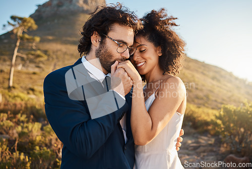 Image of Love, kiss and wedding with couple in nature for celebration, happiness and romance. Sunset, hug and affectionate with bride and groom in embrace at countryside for happy, marriage and smile together