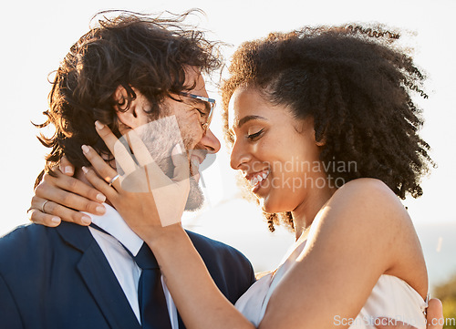 Image of Wedding, hug and marriage of a interracial couple in nature happy about trust and commitment. Outdoor marriage, sea and mock up with happiness and smile of bride and man in a suit at a event