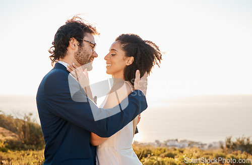 Image of Love, wedding and bride with groom on mountain for marriage ceremony, commitment and celebration. Romance, happiness and interracial couple bonding, kiss and smile with ocean, nature and outdoors