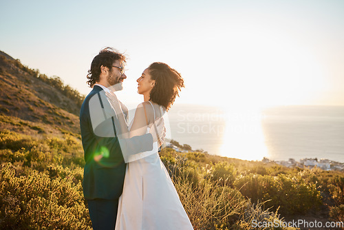 Image of Wedding, love and couple on mountain for marriage ceremony, commitment and celebration. Romance, happiness and interracial bride and groom bonding, share intimate moment and smile by ocean in Italy