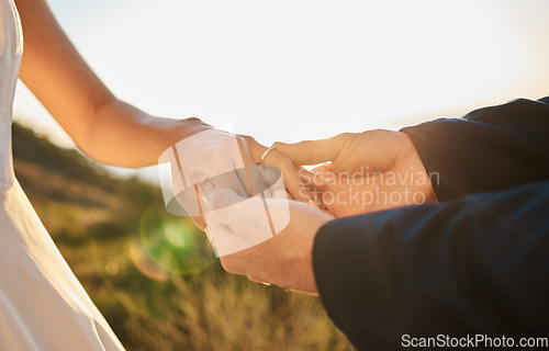 Image of Couple hands, wedding ring and marriage trust, hope and love together in nature outdoor. Bride, groom and save the date event, support and jewellery for celebration, relationship solidarity and unity