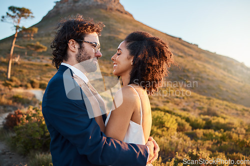 Image of Love, wedding and bride and groom on mountain for marriage ceremony, commitment and celebration. Trust, happy and interracial couple bonding, hug and smile on romantic holiday, vacation and honeymoon