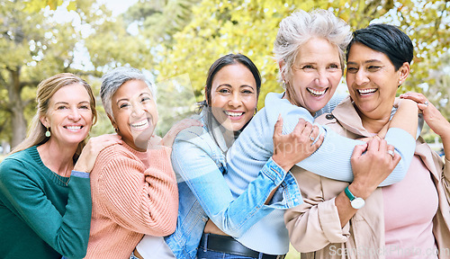 Image of Friends, park and group of women hug enjoying bonding, quality time and relax in nature together. Diversity, friendship and portrait of happy senior females with smile, embrace and peace outdoors