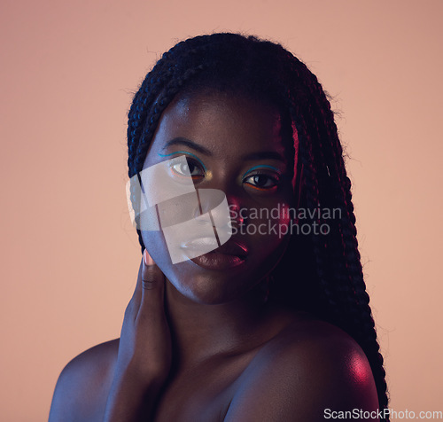 Image of Portrait, hair and beauty with a model black woman in studio on a wall background for natural haircare. Face, makeup and braids with an attractive young female posing to promote keratin treatment