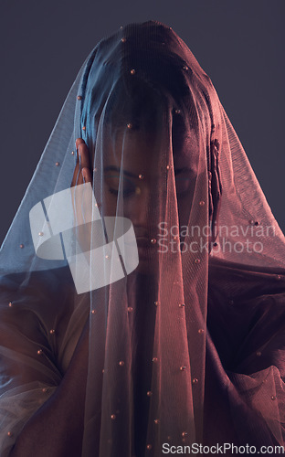 Image of Fashion, veil and woman in studio for creative, textile and elegance against a dark background. Fabric, girl and model covered in material, vintage and retro style while standing, posing and isolated