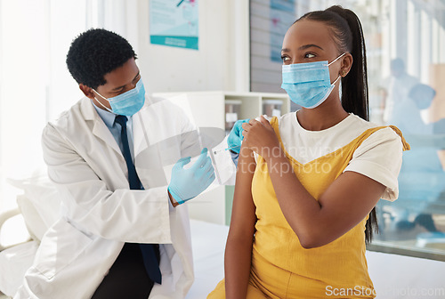 Image of Injection, doctor and patient with health, Covid and hospital, black people with healthcare and vaccine. Medicine for safety against virus, needle syringe and man with woman in mask for Corona