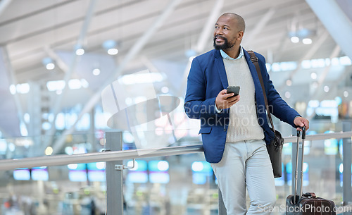 Image of Businessman, phone and luggage at airport for travel, journey or checking flight times or destinations. Happy black man, person or employee holding smartphone for schedule, traveling or work trip