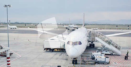 Image of Airport runway, global travel and airplane ready for takeoff, international flight and commercial transportation. Air transport, journey and plane at terminal loading cargo, baggage and luggage