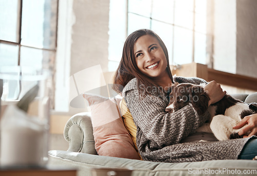 Image of Woman relax on couch with dog, smile and content at home with pet and happy together with peace in living room. Happiness, love for animals and care with female and puppy, cuddle on sofa in apartment