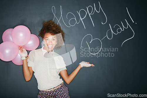 Image of Excited, happy birthday balloons and portrait of a model and chalkboard for celebration. Happy, smile and excited person with birthday words and party sign to celebrate fun event with style in studio