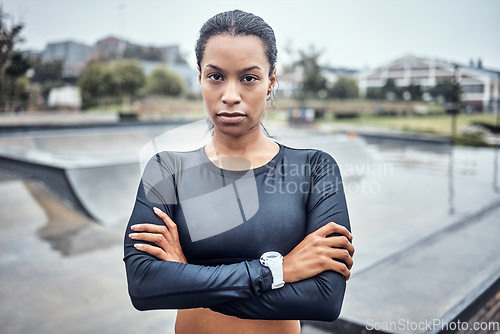 Image of Fitness, sports and portrait of a woman in the city for an outdoor run, exercise or training. Serious, motivation and young female athlete or runner with crossed arms after a cardio workout outside.
