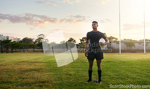 Image of Rugby player, sports and standing on field with ball ready for game, match or practice outdoors. Sporty man athlete or professional waiting for rugby competition, training or play time on green grass