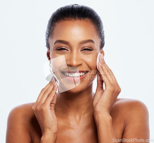 Image of Black woman, beauty and cotton on face portrait in studio for dermatology, cosmetics and natural skin. Happy aesthetic model cleaning makeup for self care facial glow isolated on a white background